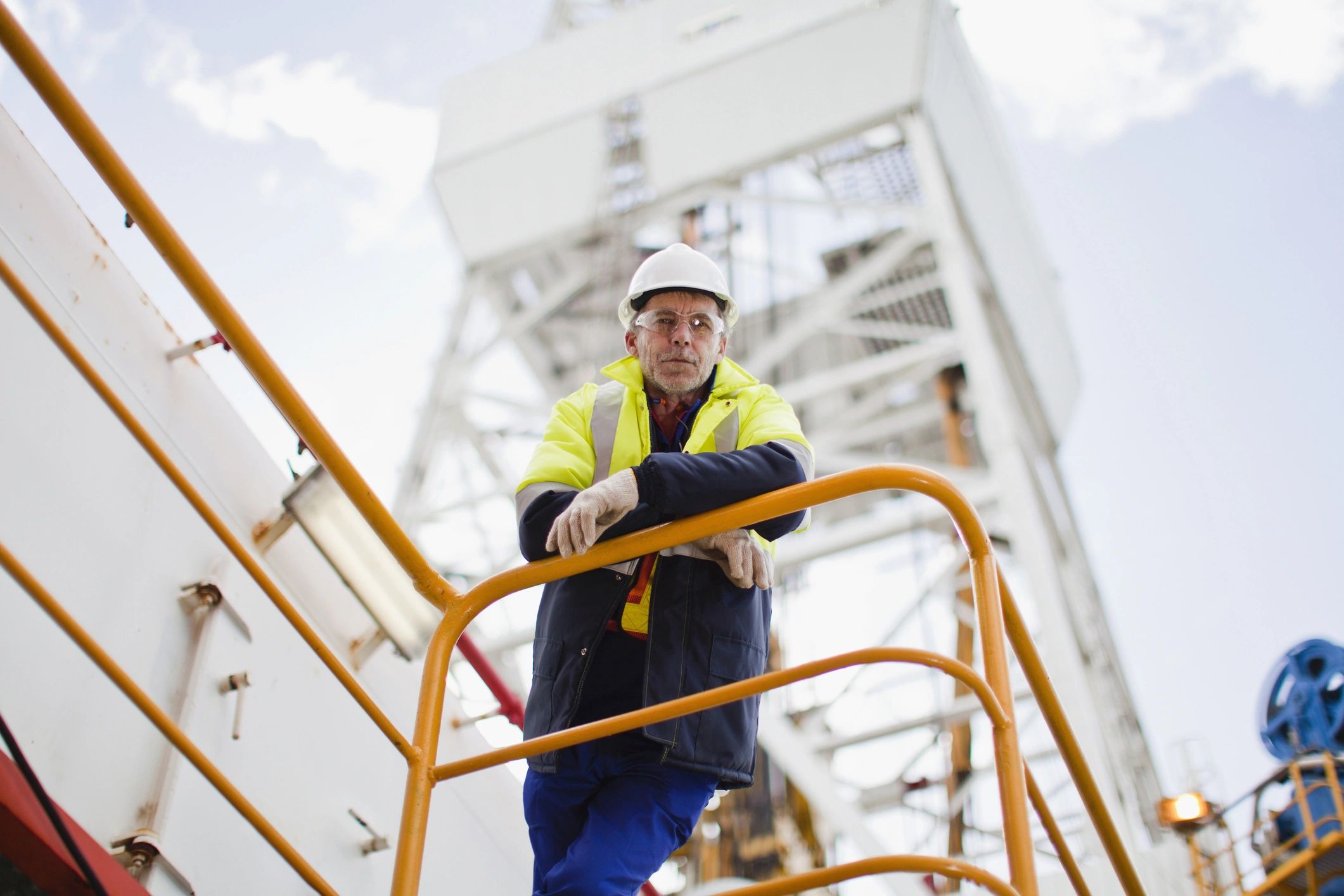 Offshore worker on an oil rig looking out over the platform