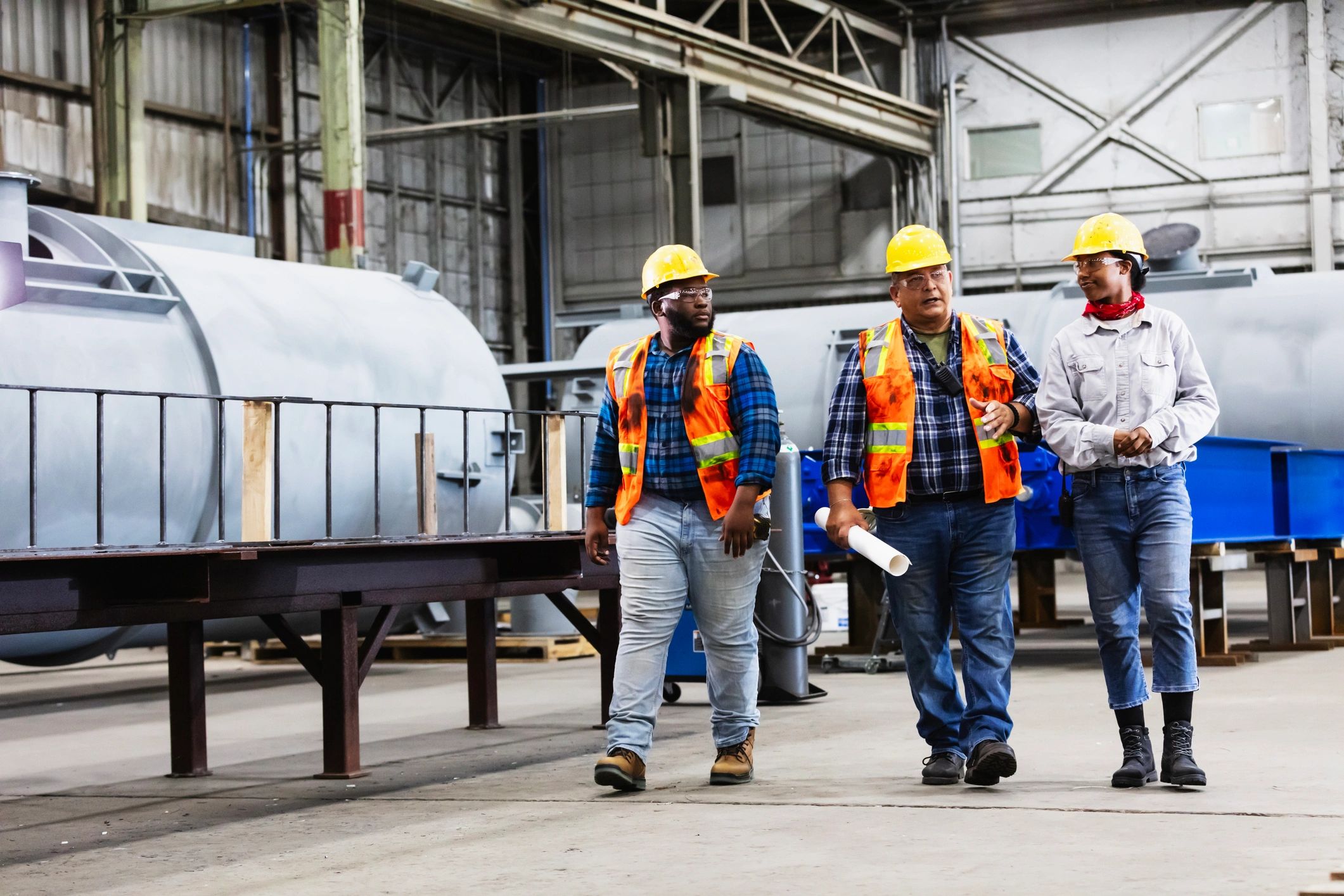 Engineers reviewing plans on an industrial site